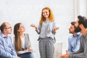 People participate in a recovery meeting.