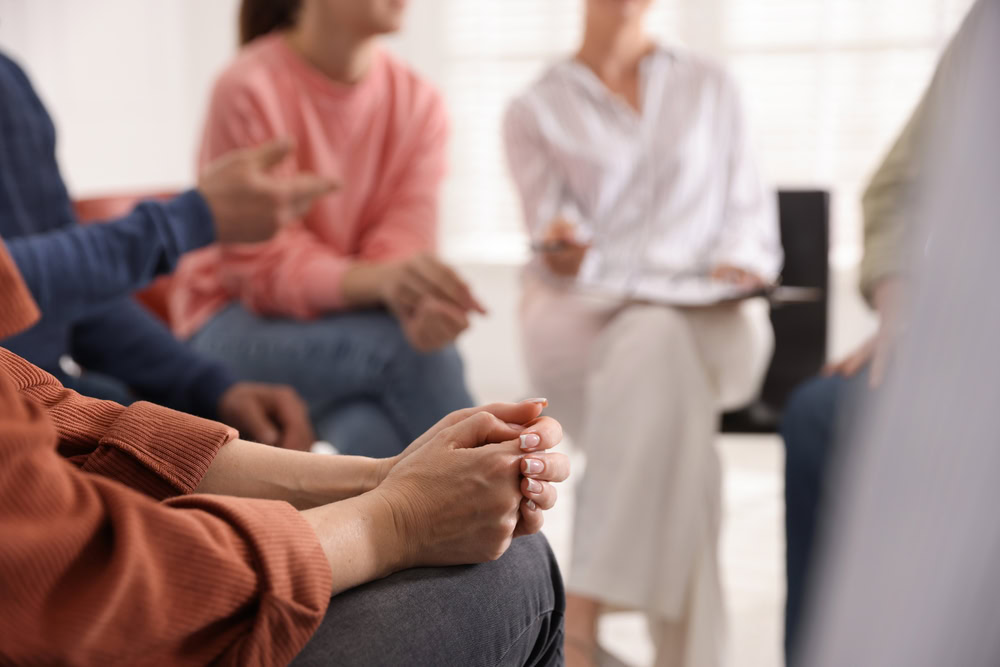 Group therapy session talking about how nalaxone can save lives.