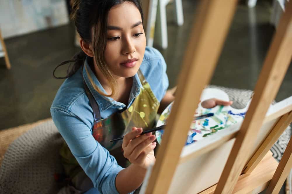 Young Asian woman learning how to find your passion when you are depressed by painting.