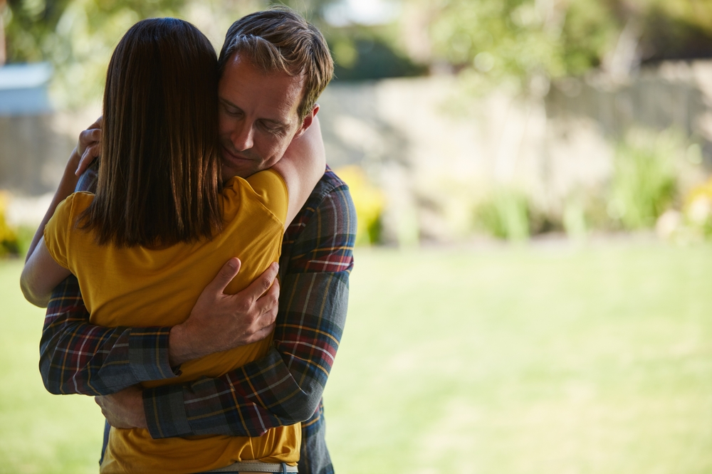 Man and woman hugging showing how to help your partner in recovery.