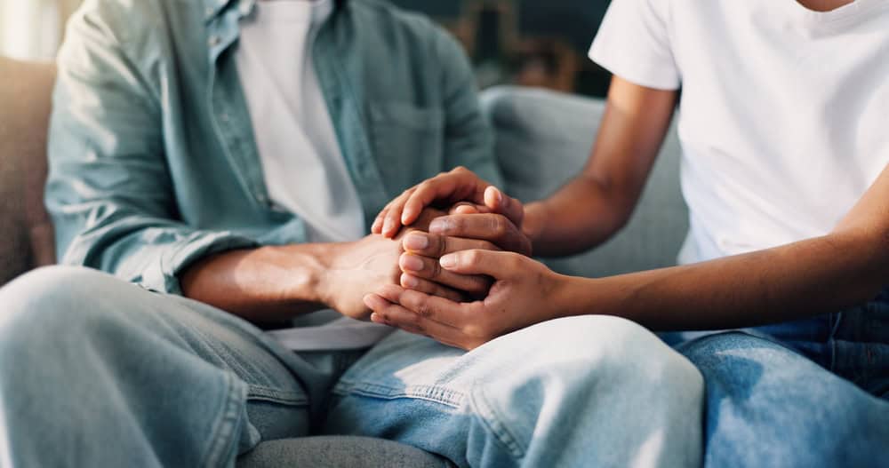 Man and woman supporting each other in recovery.